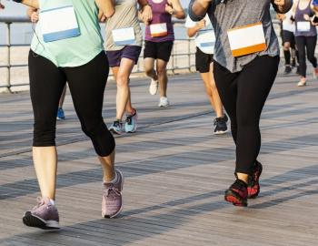 runners on a boardwalk 