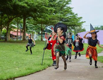 Kids running in halloween costumes 