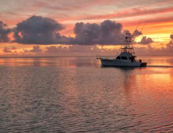 A fishing charter boat leaves very early in the morning