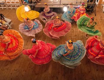 women dancing in colorful dresses