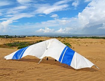 A hang glider sitting on a sand dune at Jockeys Ridge State Park