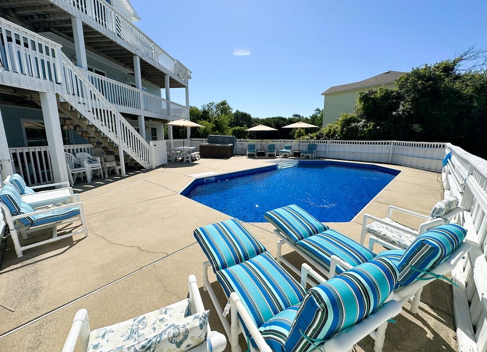 Vacation rental exterior with pool and outdoor seating