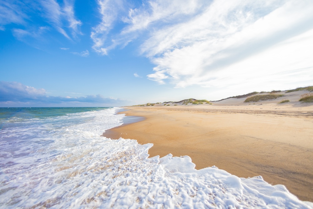 Sand dunes and a quiet beach shoreline