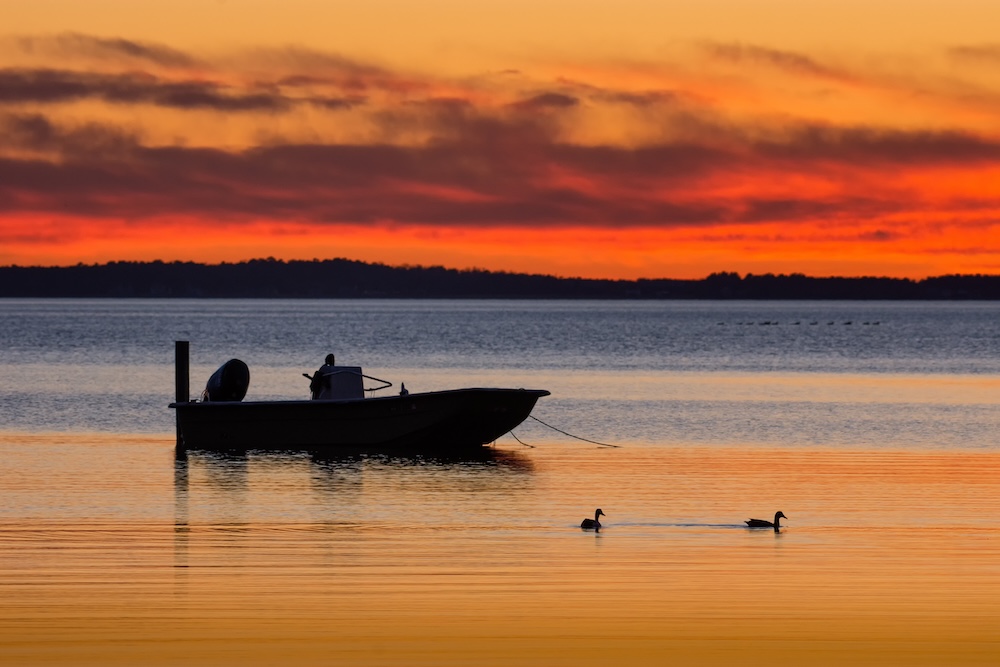 Boat in the sound at sunset
