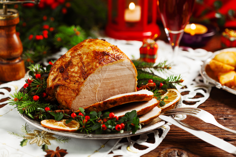 table set for christmas dinner with close up on a sliced turkey