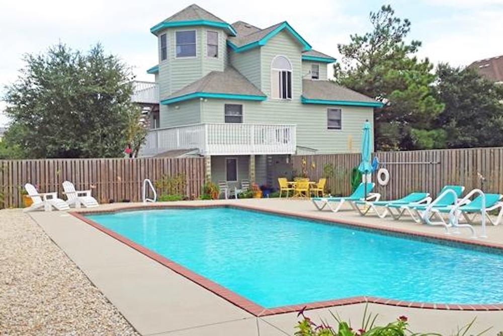 vacation rental with view of pool and exterior of home in the outer banks