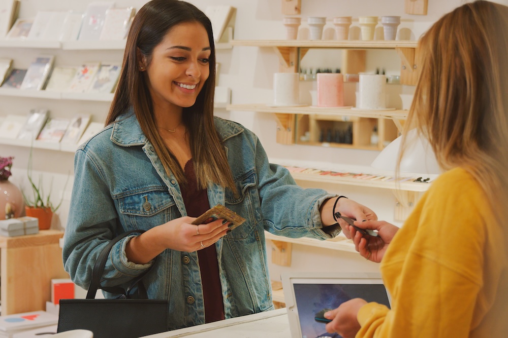 A woman using a credit card to pay for her goods